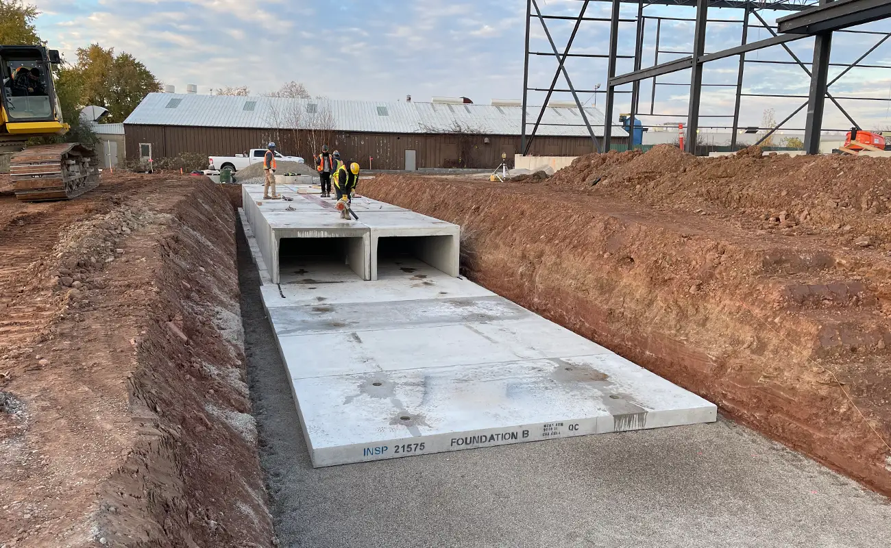 StormTrap SingleTrap installation at 4455 North Service Burlington Ontario showing precast concrete foundation slab in excavation