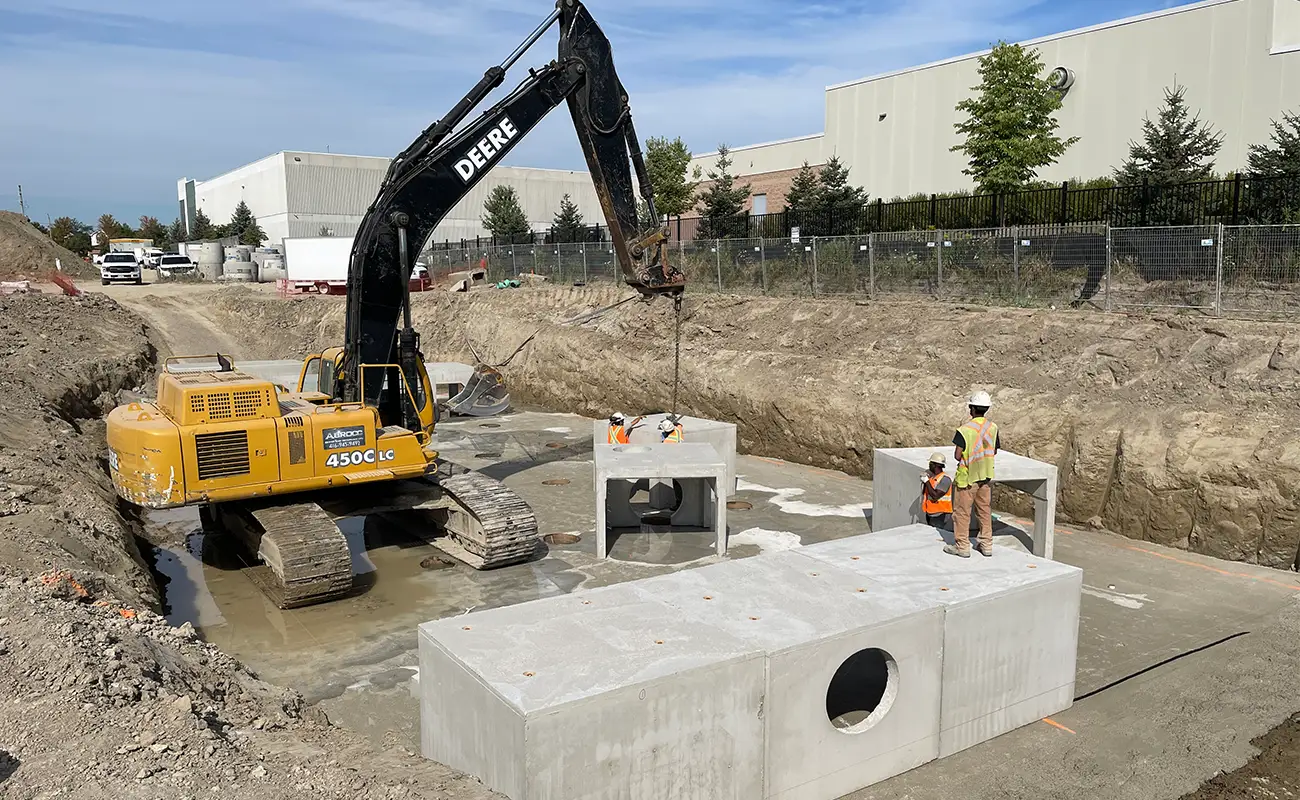 StormTrap SingleTrap units with infiltration openings being installed adjacent to a completed warehouse, Ajax Ontario