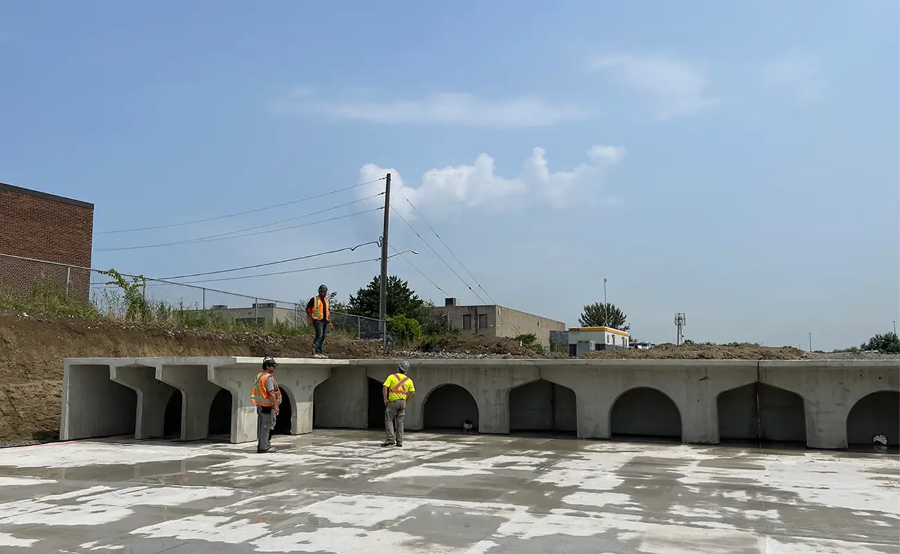 Workers inspecting StormTrap SingleTrap precast concrete infiltration basin at MTO jurisdiction project, Brampton Ontario