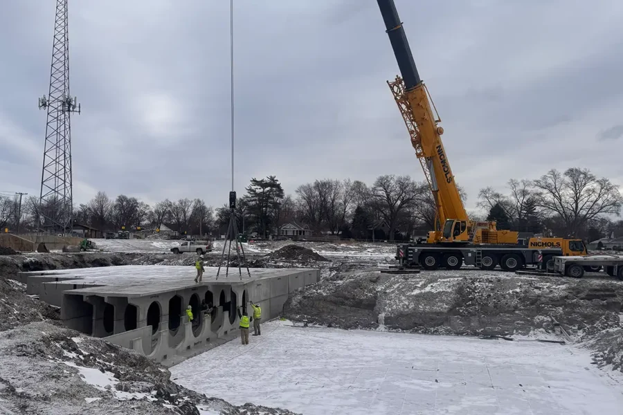 StormTrap DoubleTrap detention system being lowered into excavation by crane during installation in Oak Lawn, Illinois