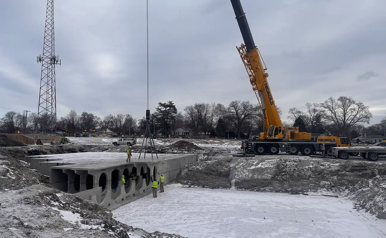 StormTrap DoubleTrap detention system being lowered into excavation by crane during installation in Oak Lawn, Illinois