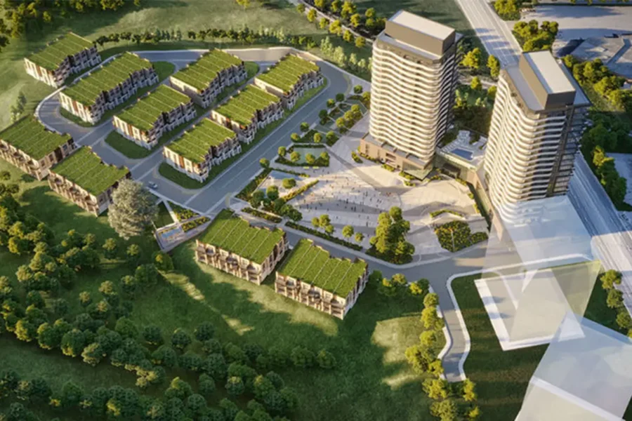 Aerial view of a residential complex with two high-rise buildings, several rows of townhouses, green roofs, roads, and surrounding trees. Aerial rendering of Hillmont at SXSW Condos residential development in Vaughan Ontario