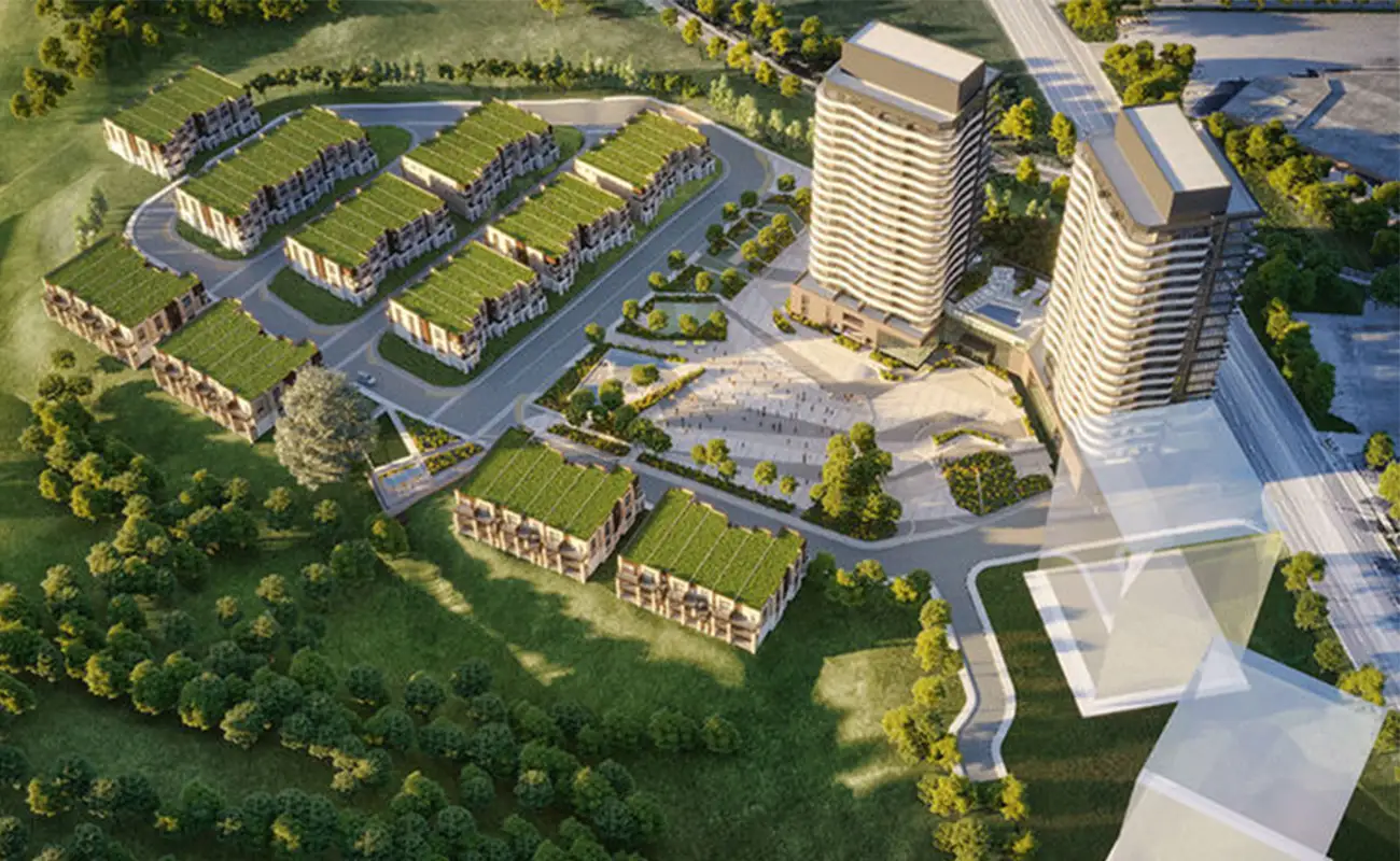 Aerial view of a residential complex with two high-rise buildings, several rows of townhouses, green roofs, roads, and surrounding trees. Aerial rendering of Hillmont at SXSW Condos residential development in Vaughan Ontario