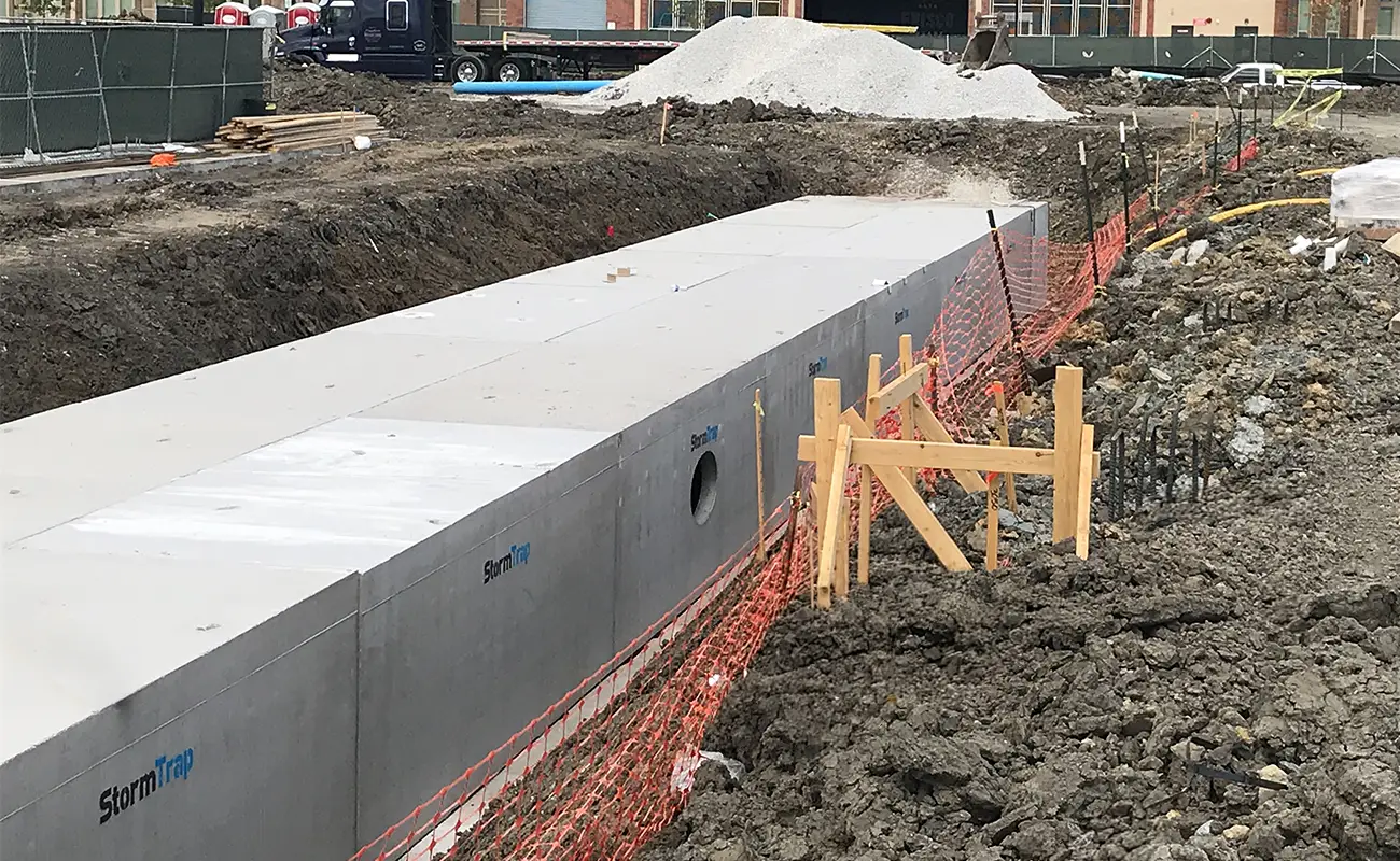Precast concrete StormTrap drainage segments installed in a trench for a detention system in Frisco, Texas.