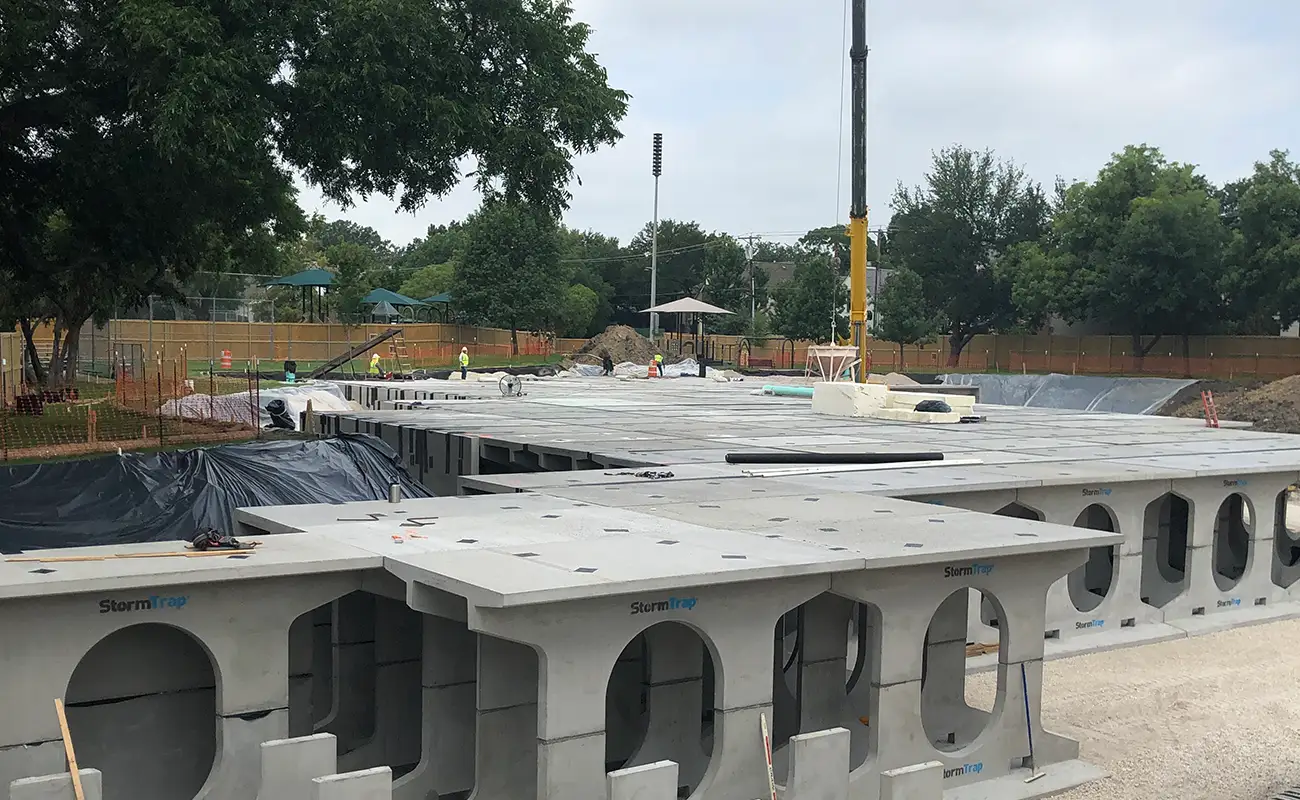 Concrete StormTrap underground stormwater detention system modules installed at a construction site in University Park.